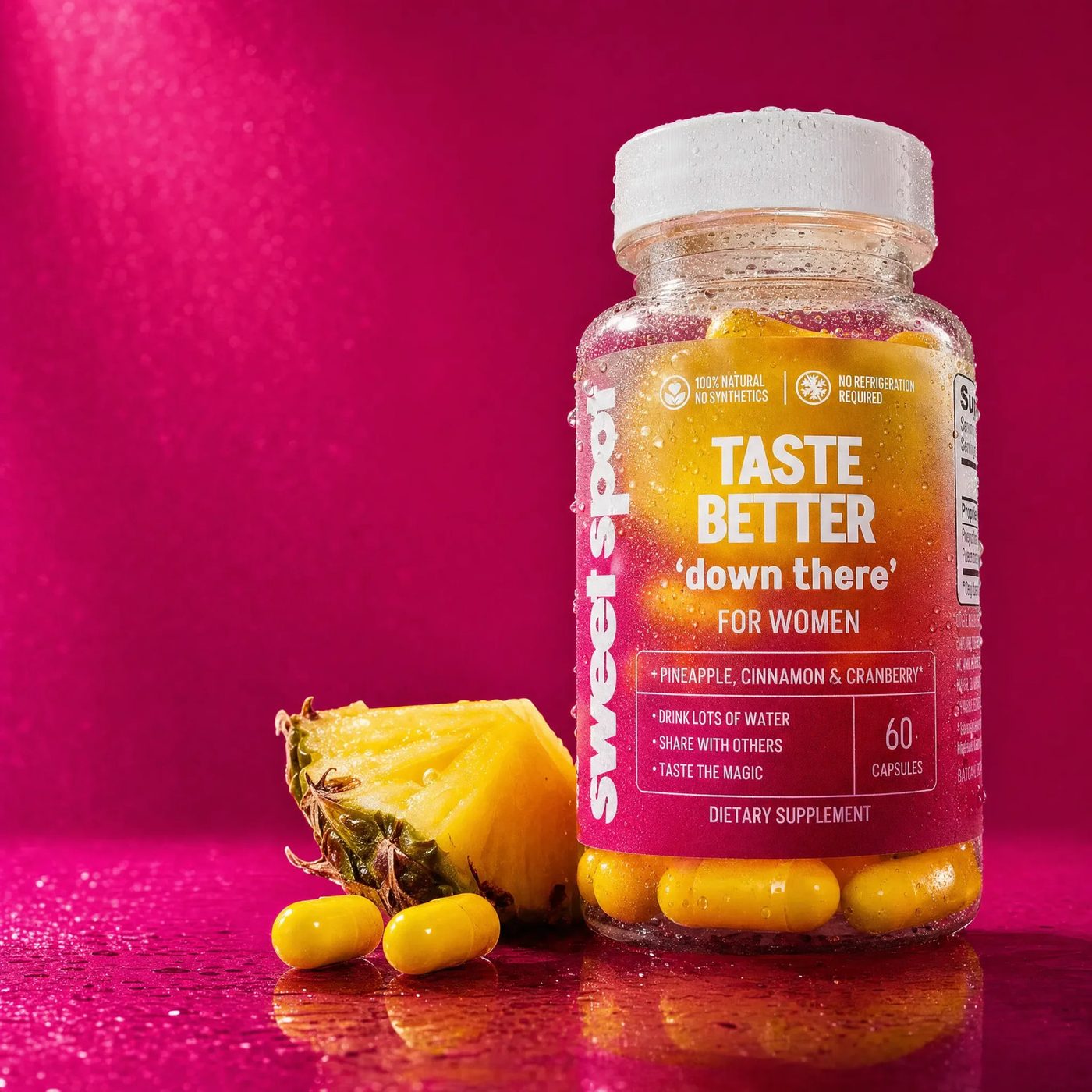 Taste Better For Women bottle with pineapple and two yellow capsules on a magenta background.
